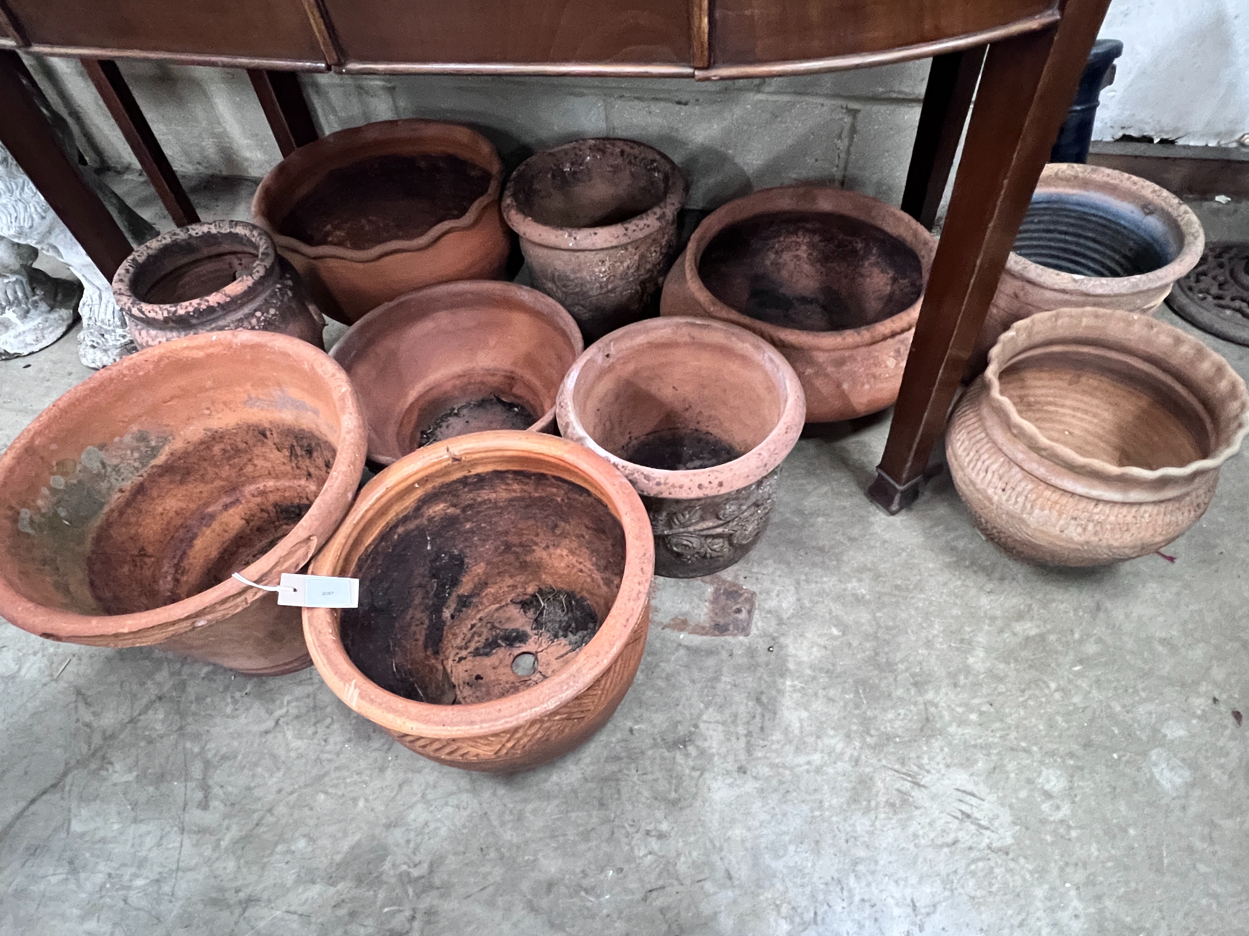 Ten assorted terracotta garden planters, largest diameter 43cm